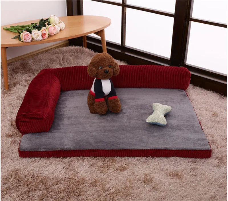 A corduroy dog sofa bed with raised sides, shown in a grey colour, placed on a wooden floor.