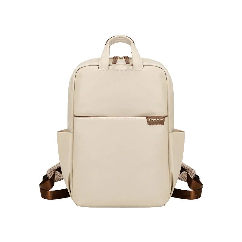 Simple large capacity women's canvas travel backpack in apricot colour, showing front view and organisational pockets.
