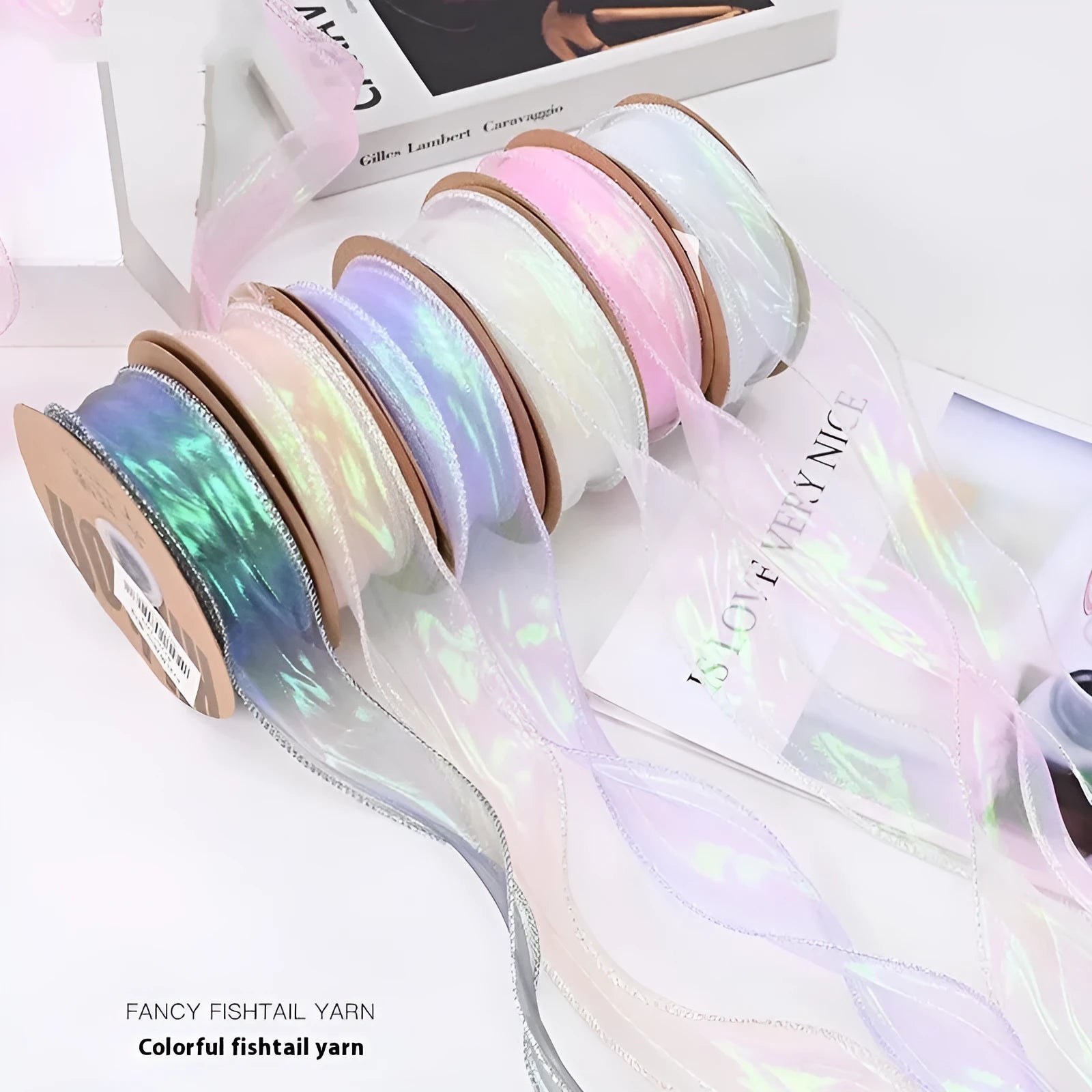 Colourful 4cm fishtail yarn craft ribbon on roll showing textured mesh construction