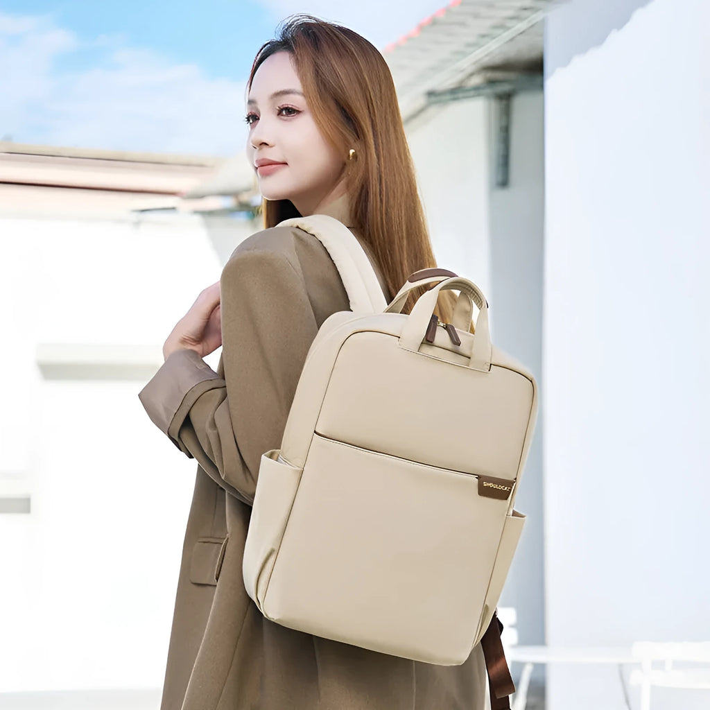 Simple large capacity women's canvas travel backpack in apricot colour, showing front view and organisational pockets.