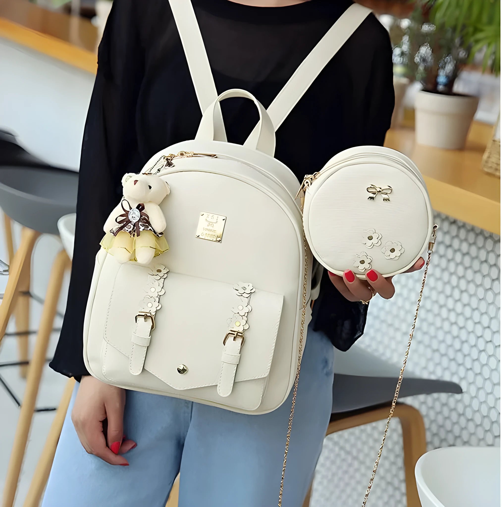 Women's three-piece floral PU leather bag set showing backpack, shoulder bag, and card purse in black.