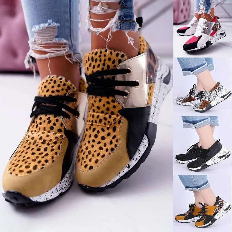 Women's casual flat sneakers in leopard print with suede upper and a low wedge heel.