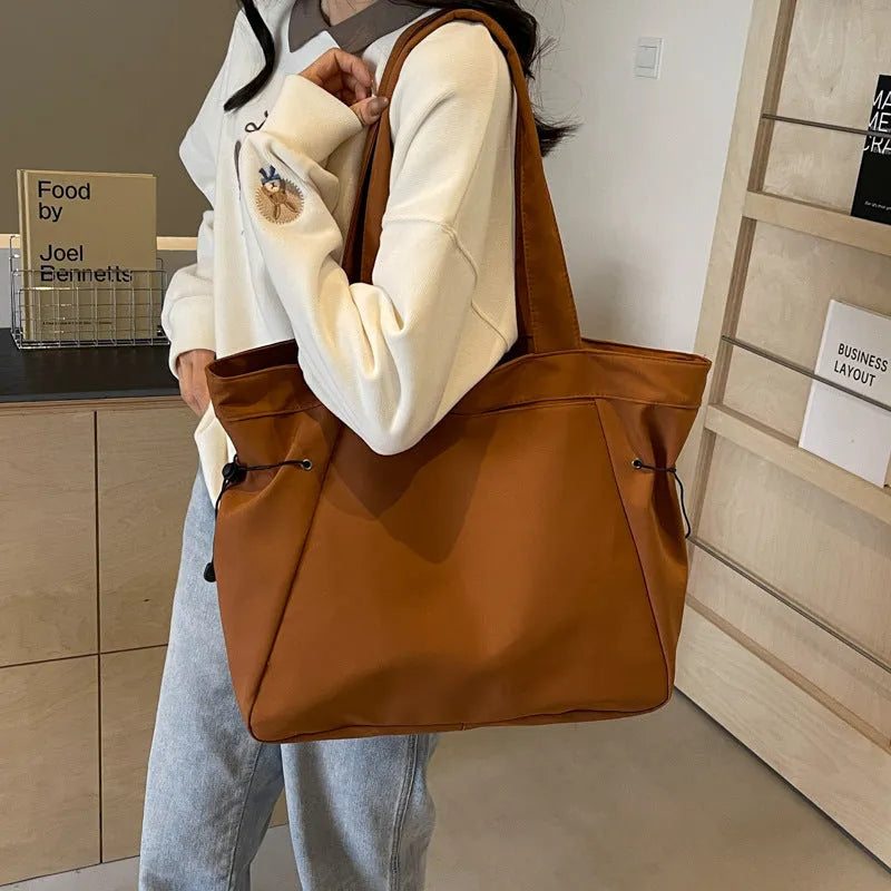 Soft Oxford cloth folding tote bag in a choice of five colours: black, brown, dark grey, light grey, and purple.