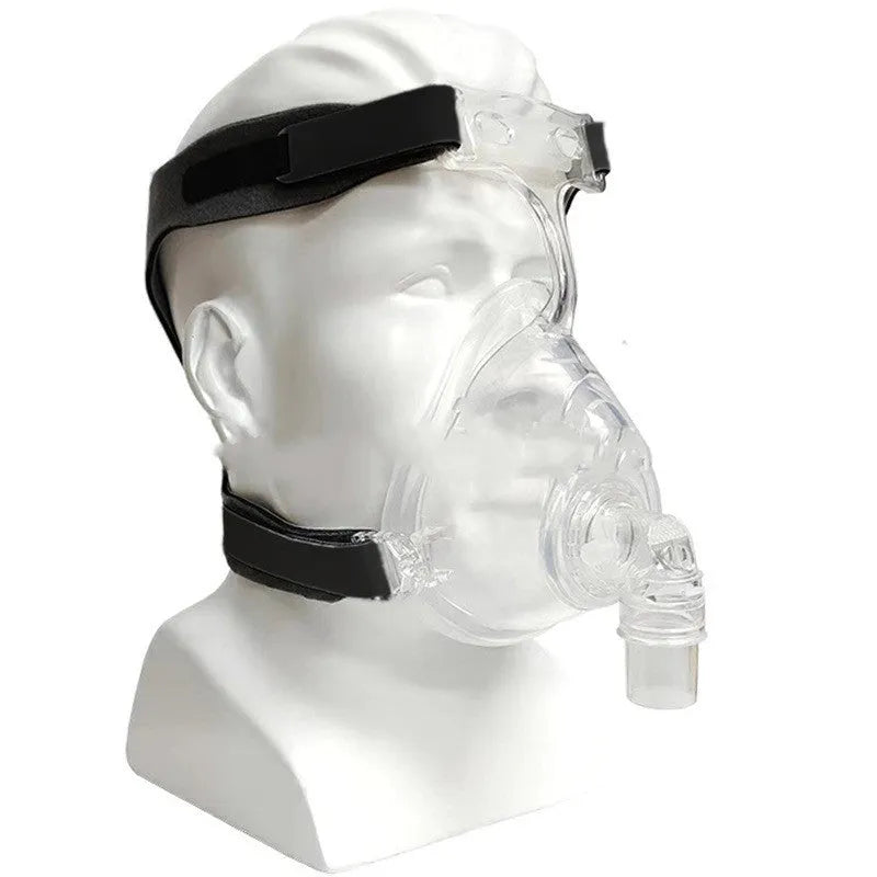 Transparent silicone CPAP breathing mask with headband and two PC adapter elbows on a white background.