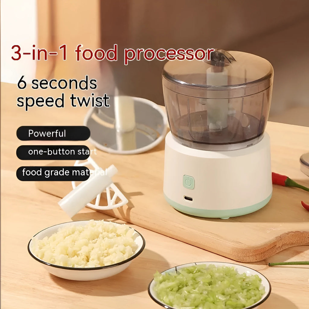 White mini electric meat grinder with transparent cup and stainless steel blades on a kitchen worktop