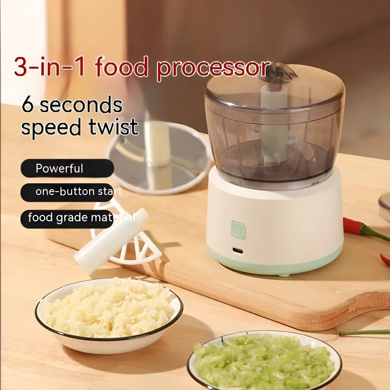 White mini electric meat grinder with transparent cup and stainless steel blades on a kitchen worktop
