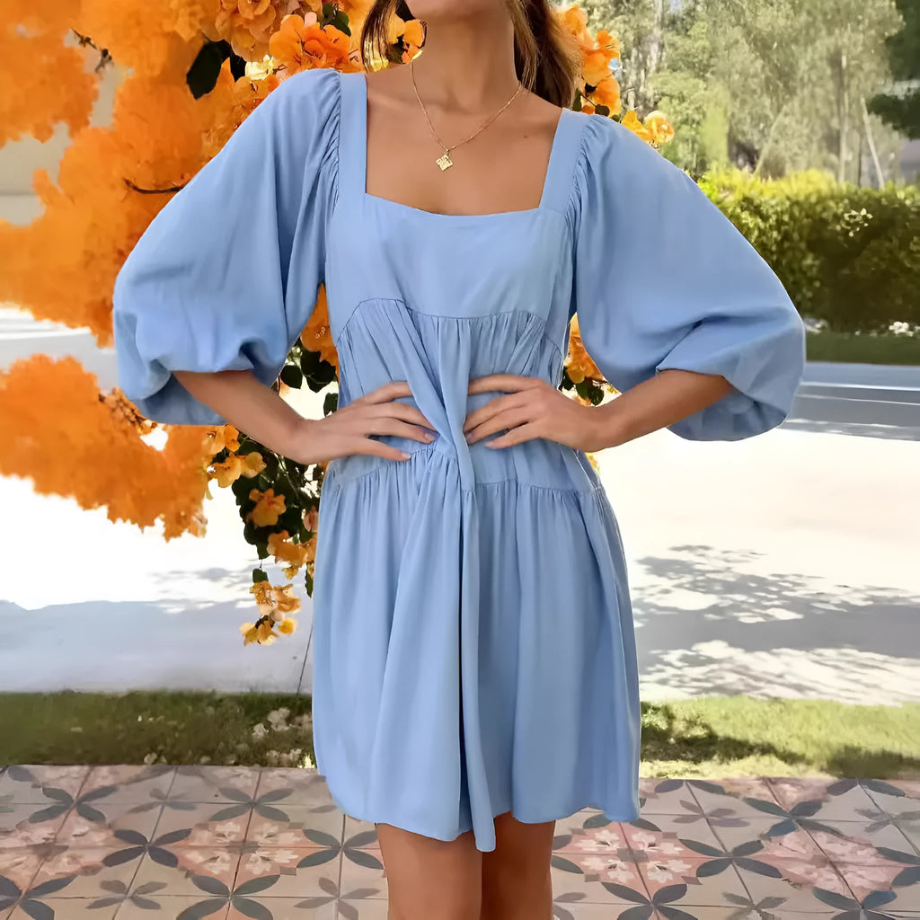 Orange children's dress with puff sleeves, square collar, backless design, and A-line skirt