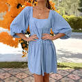 Orange children's dress with puff sleeves, square collar, backless design, and A-line skirt