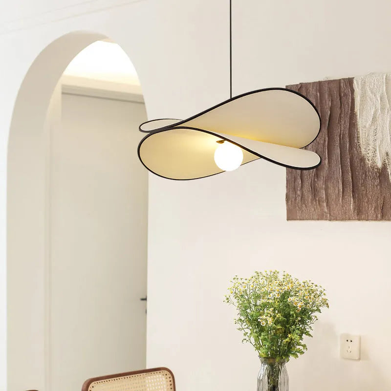 French artistic modern fabric potato chips chandelier pendant light in a bedroom setting.
