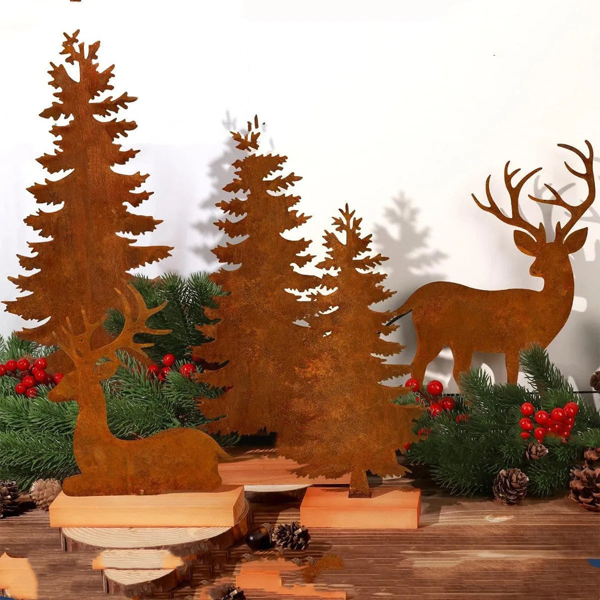 Set of three rusty metal Christmas tree decorations with elk silhouettes on a rustic surface.