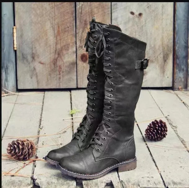 Women's black chunky heel high leg ankle boots with a round toe and low rubber sole.