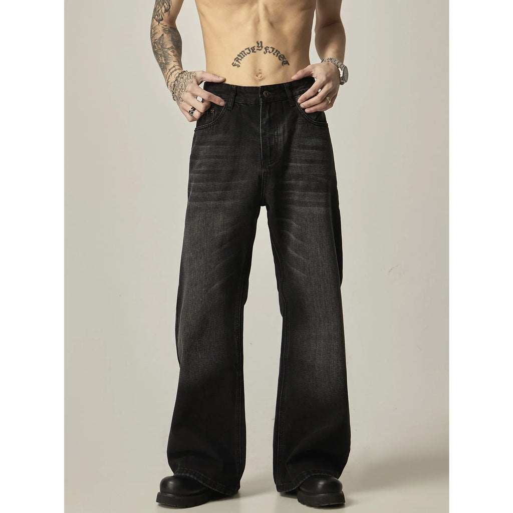 Black loose-fit straight-leg retro jeans with a zip fly on a neutral background.