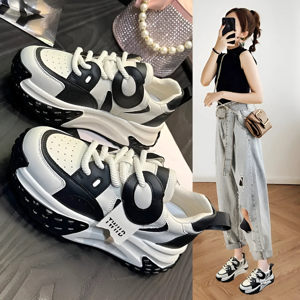 Pair of thick-soled leather sports casual shoes with wedge heels and front lace-up fastening.
