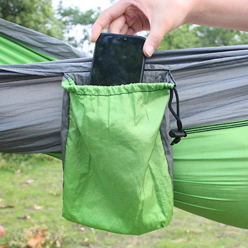 Blue nylon parachute cloth outdoor hammock hanging between trees