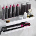 White punch-free double-layer aluminium rack holding Marcel waving irons on a bathroom wall.