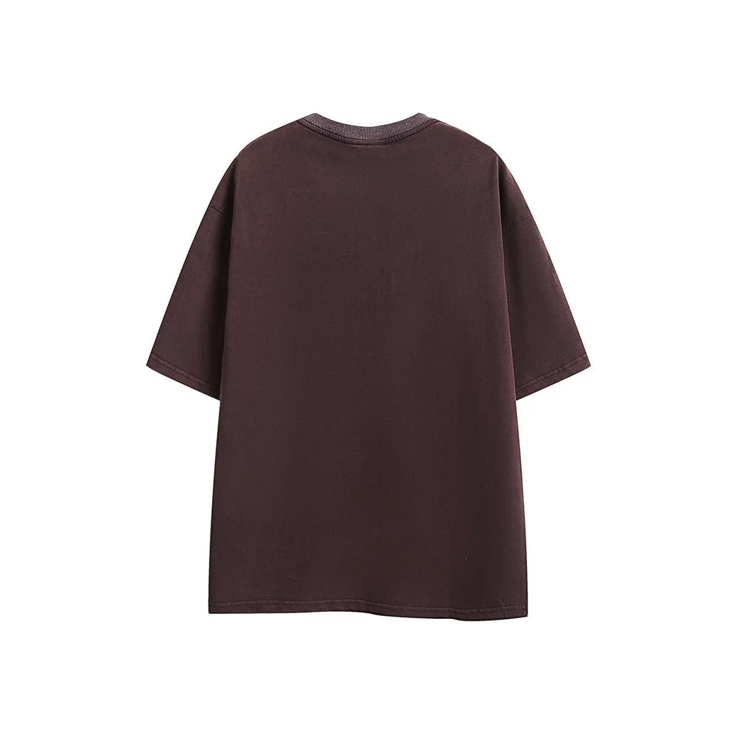 Loose retro-style short-sleeve cotton t-shirt with embroidered detailing in black or purple colour.