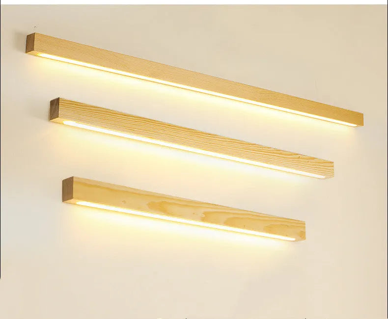 Walnut colour solid wood and acrylic LED strip wall lamp in three different lengths.