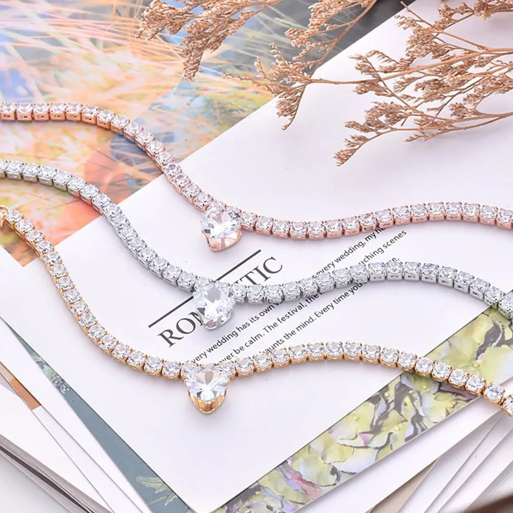 Gold rhinestone heart-shaped collar for dogs or cats on a white background.