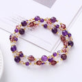Handmade adjustable bracelet with three crystal rings: tourmaline, strawberry quartz, and amethyst.