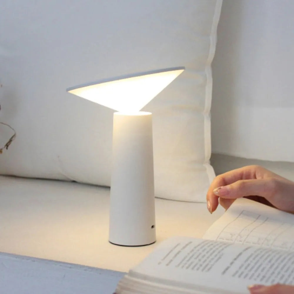 Black USB LED desk lamp with touch sensor base and an angled lamp head on a wooden desk.