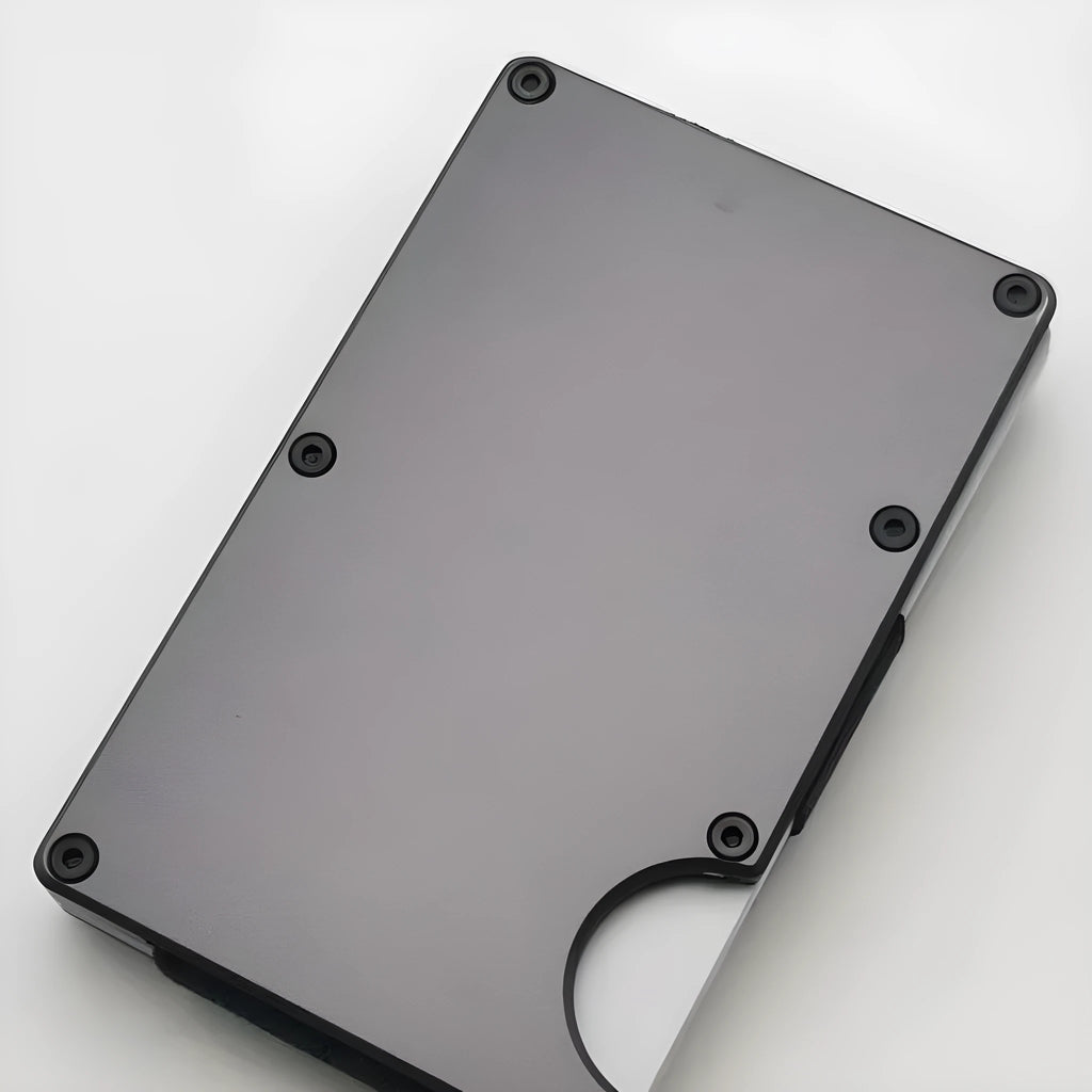 Aluminium alloy grey carbon fibre credit card wallet with RFID blocking feature, showing slim stowable profile.