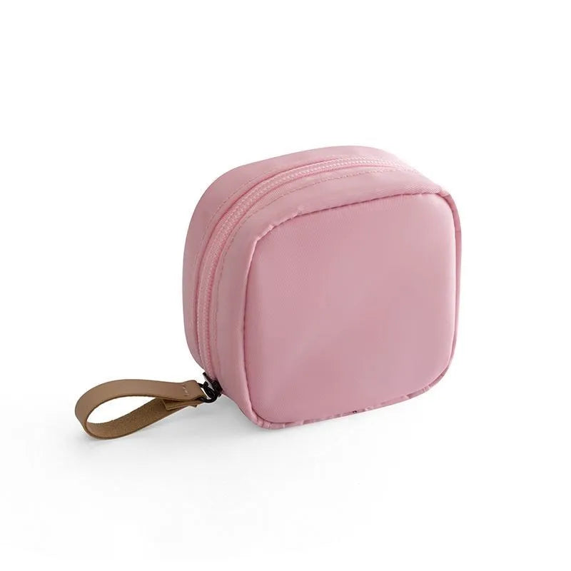 Cloth makeup storage bag in cube shape with plain pattern, shown in available colour options