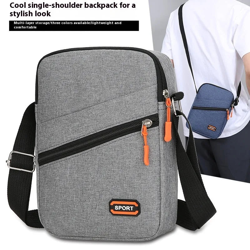 Lightweight Oxford cloth crossbody commuter bag in a solid colour with contrast detail.