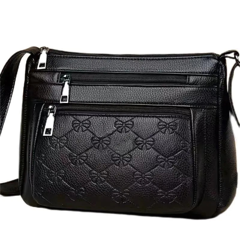 Black women's crossbody messenger bag with embossed texture and shoulder strap