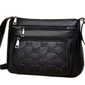 Black women's crossbody messenger bag with embossed texture and shoulder strap