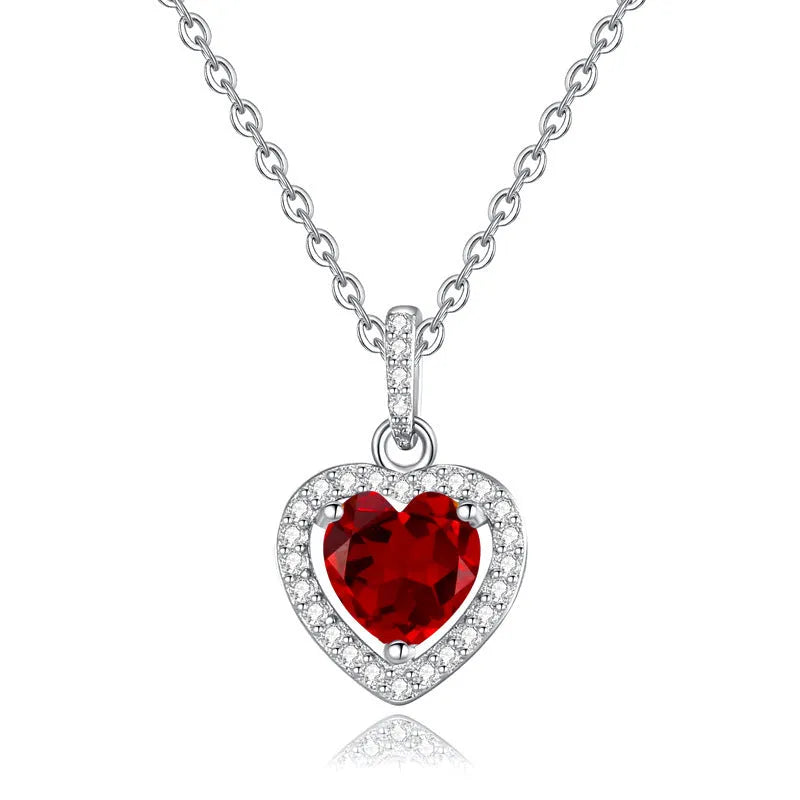 Sterling silver heart necklace with a natural amethyst gemstone on a cross chain.