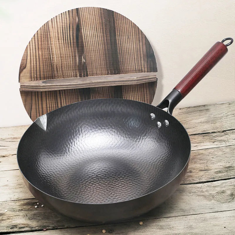 Black traditional iron wok with wooden handle measuring 40cm diameter