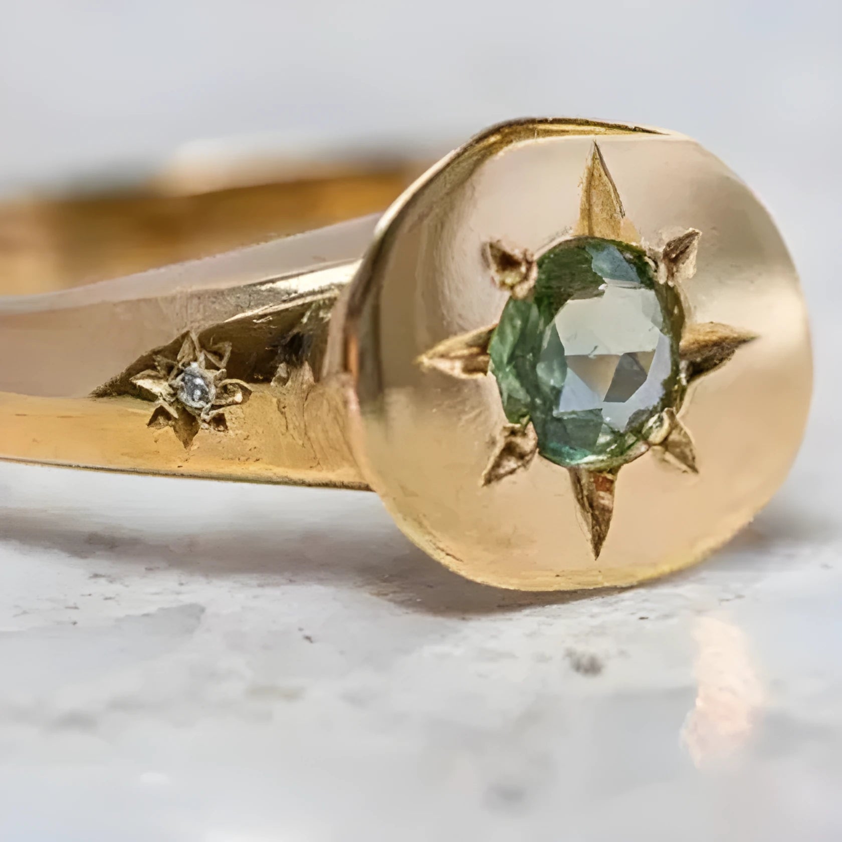 Golden oval asterism star ring with zircon stones and an adjustable opening.