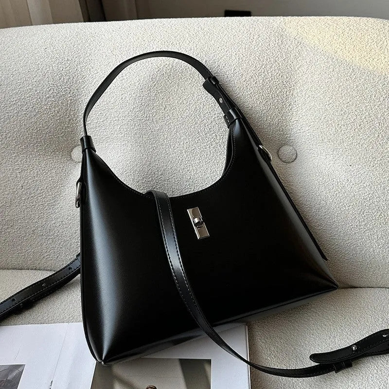 Women's soft genuine leather crossbody shoulder bag in a dumpling shape, shown in a light colour.