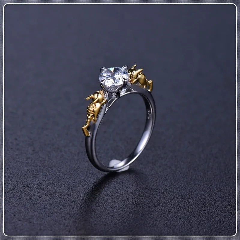 Black gold copper crown crystal ring for cosplay on a grey background.