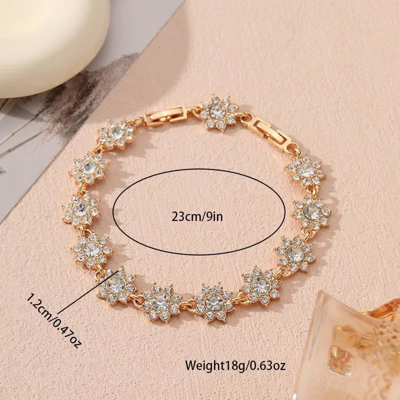 Gold and silver tone zinc alloy flower bracelet with electroplated coloured gemstones including crystal and diamond accents.