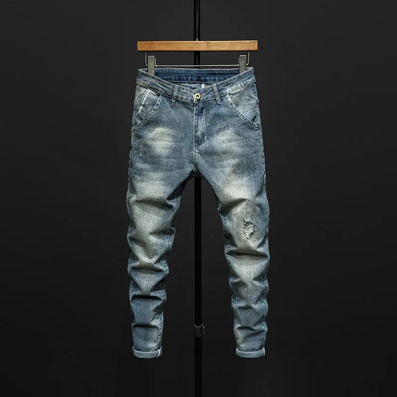 Men's dark blue skinny jeans with a slim fit, shown on a model.