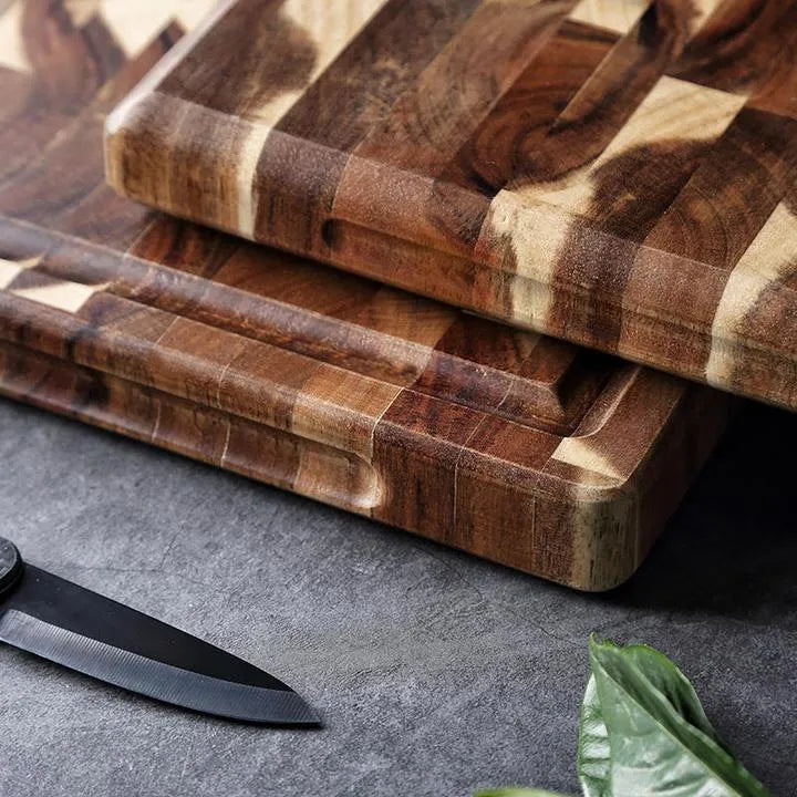 Brown solid acacia wood chopping board with 3cm thickness on a kitchen countertop