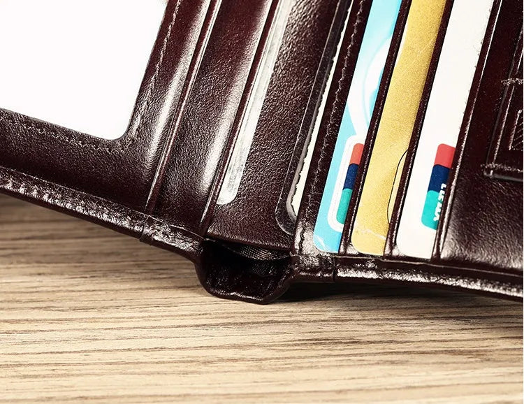 Men's black leather wallet open to show internal card slots, coin pocket, and document sleeve.