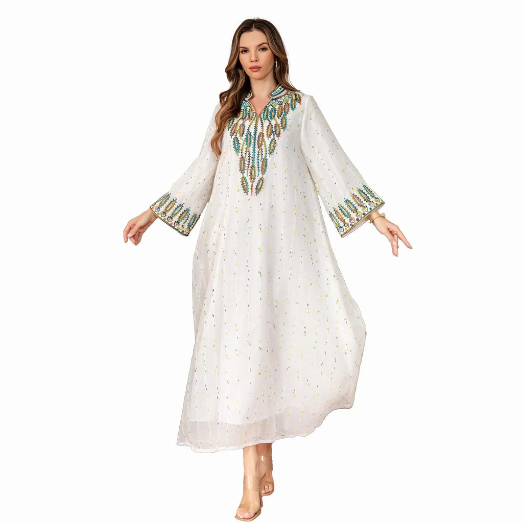White long Arabic robe dress for women with long sleeves on a hanger