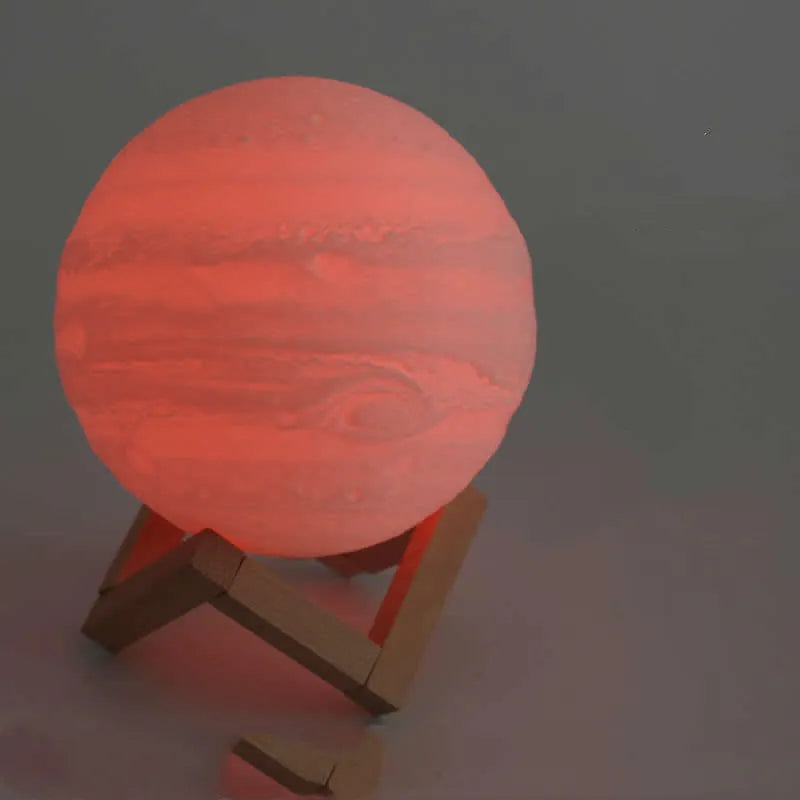 3D printed white moon lamp on a wooden stand, showing detailed craters and soft LED glow.