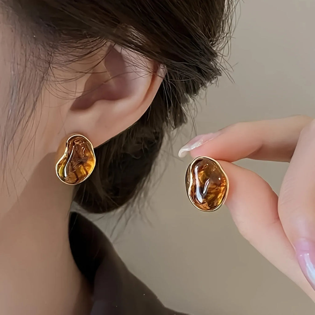 Three pairs of geometric holiday earrings with tassel accents in electroplated alloy