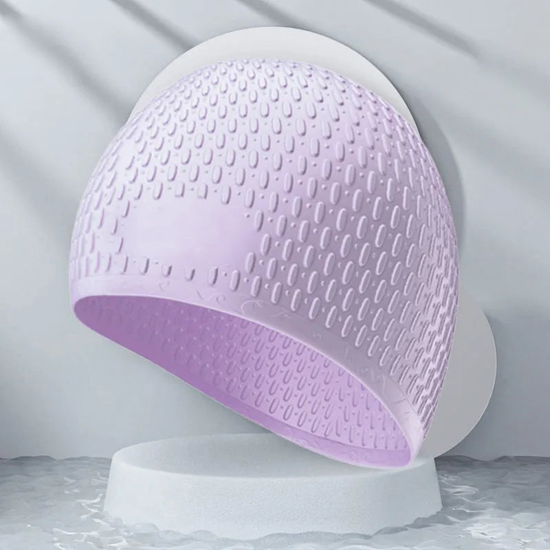 Silicone swimming cap for adults in various solid colours on a white background.