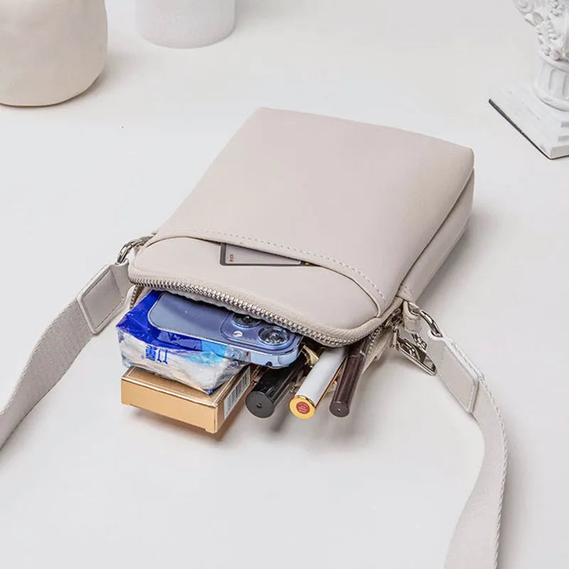 Small solid colour crossbody shoulder bag for women, shown in beige.