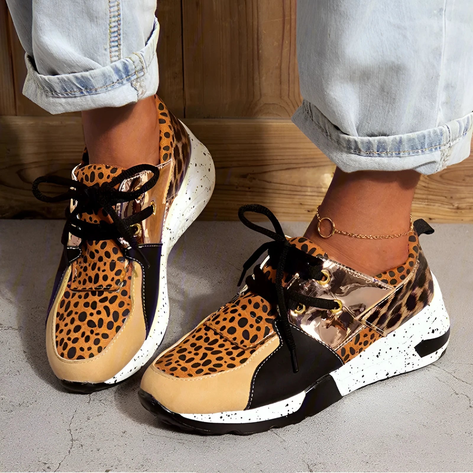 Women's casual flat sneakers in leopard print with suede upper and a low wedge heel.