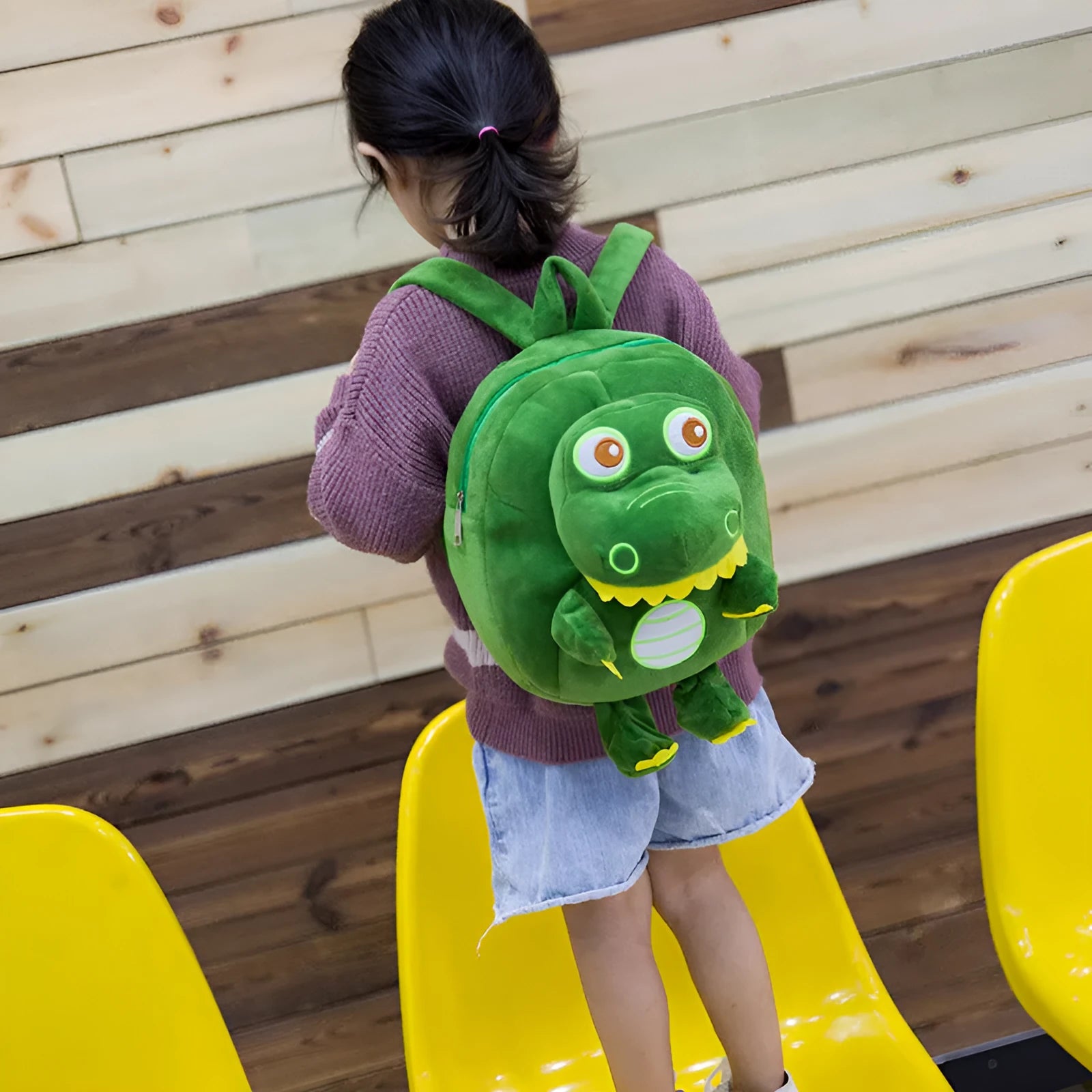 Children's dinosaur plush backpack in soft material with embroidery details and soft handle