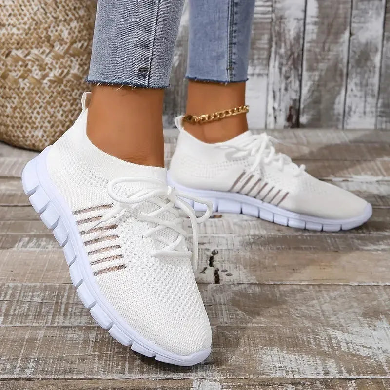 Women's breathable knit sports flat shoes in various colours on a light background.