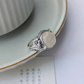 Adjustable copper vintage ring with white chalcedony stone and open mouth design