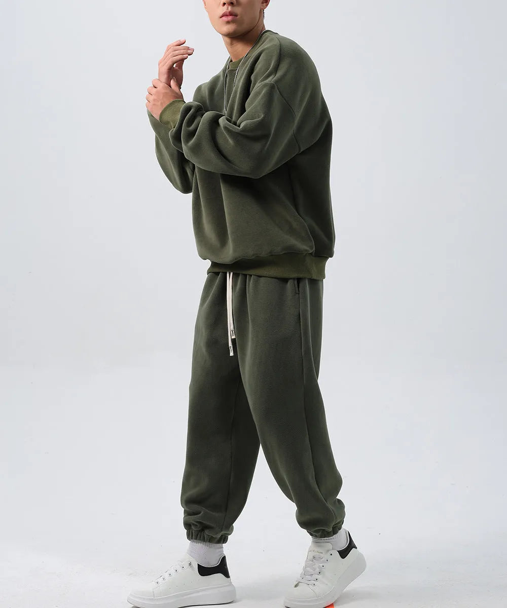 Men's black polar fleece sports suit with long sleeve crew neck coat and loose fit trousers.