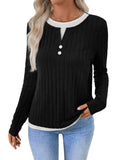 Women's black fake two-piece pullover sweater with button front and round neck on a model.