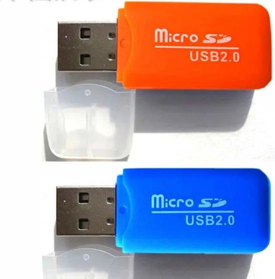 Black and silver Mini USB card reader for microSD and SD memory cards on a desk.